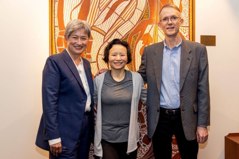 This handout photograph taken on October 11, 2023 shows Australian Foreign Minister Penny Wong (L) and Australia’s ambassador to Beijing Graham Fletcher (R) posing for pictures with Australian journalist Cheng Lei at the airport in Melbourne. — Australia’s Department of Foreign Affairs and Trade (DFAT) / AFP pic