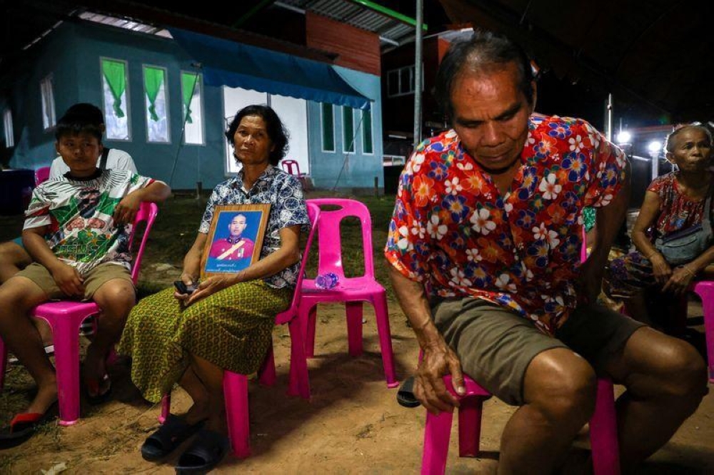 Noopar Pansa-ard, 63, holds up a picture of her son, Somkuan Pansa-ard, 39, a Thai labour who was killed in Israel in the ongoing conflict between Israel and the Palestinian Islamist group Hamas, at his house in Kalasin province, Thailand, October 10, 2023. — Reuters pic