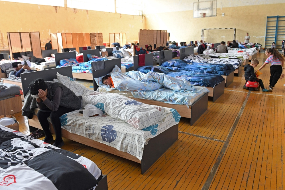 Refugees from Azerbaijan’s controlled region of Nagorno-Karabakh take shelter at a sports complex in the Armenian city of Artashat. — AFP pic