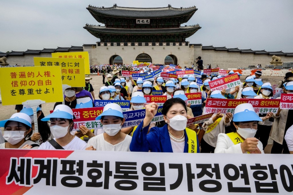 Members of the Unification Church, known officially as the Family Federation for World Peace and Unification (FFWPU), attend a rally in Seoul on August 18, 2022, to protest against the media coverage the group received in Japan following the assassination in early July of former Japanese prime minister Shinzo Abe. The Japanese government said on October 12, 2023 it will seek a court order to dissolve the Unification Church, which has been under intense scrutiny since the assassination of former prime minister Shinzo Abe. — AFP pic