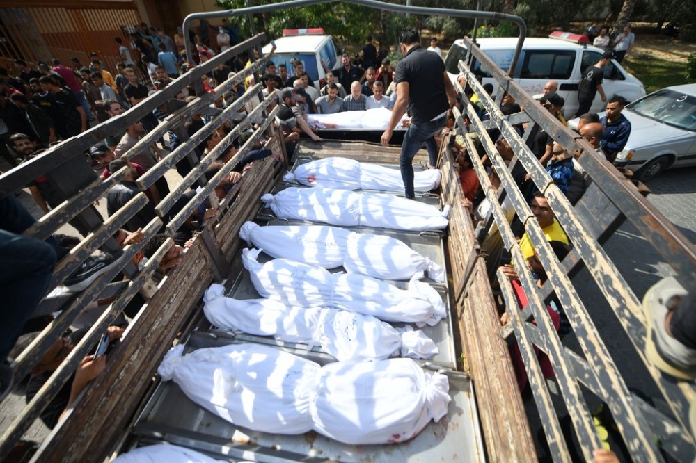 Bodies of Palestinians killed in Israeli airstrikes wait outside at the Nasser Hospital to be buried after a funeral prayer in Khan Yunis, Gaza on October 12, 2023. — Anadolu image via Reuters