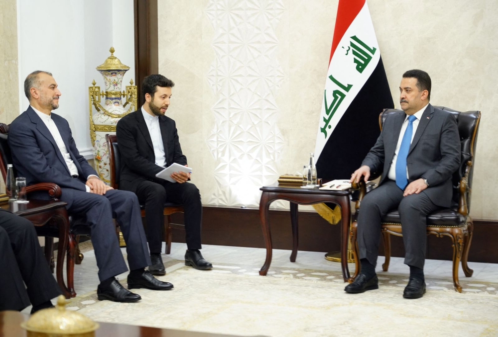 A handout image released by the press office of the Iraqi Prime Minister on October 12, 2023, shows Prime Minister Mohamed Shia al-Sudani (right) meeting with Iran's Foreign Minister Hossein Amir-Abdollahian (left) in Baghdad. — Iraqi Prime Minister's Office / AFP pic