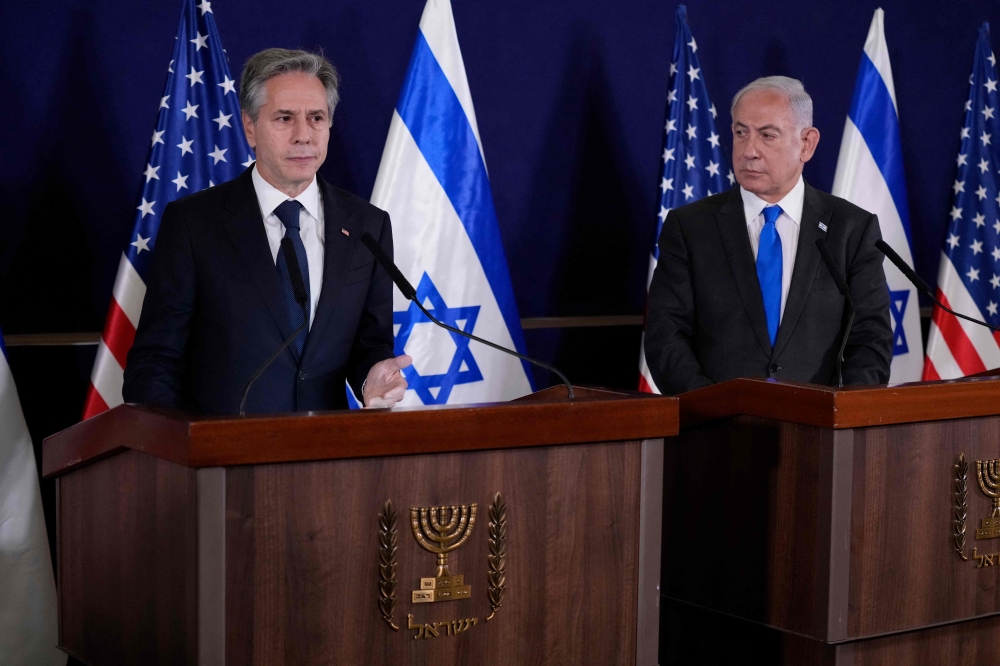 Israeli Prime Minister Benjamin Netanyahu looks on as US Secretary of State Antony Blinken gives statements to the media inside The Kirya, which houses the Israeli Defence Ministry, after their meeting in Tel Aviv on October 12, 2023. — AFP pic