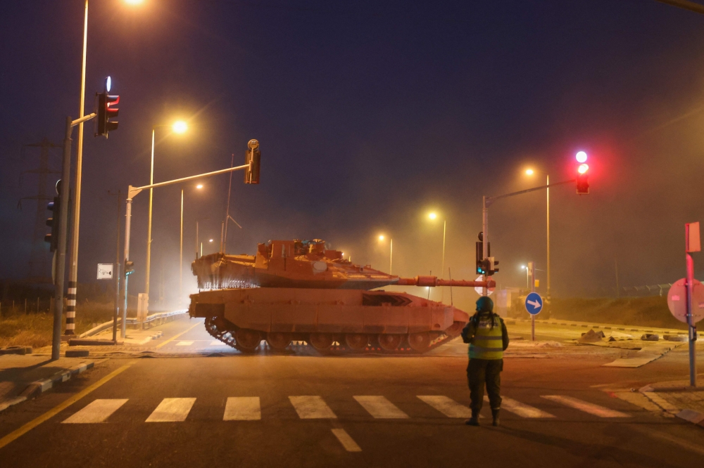 A convoy of Israeli armoured vehicles advances near the border with Gaza on October 12, 2023. — AFP pic
