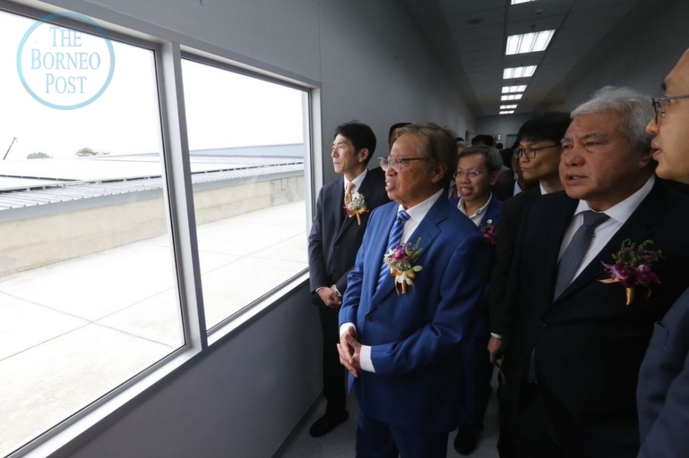 Datuk Patinggi Tan Sri Abang Johari Openg taking a tour around the new factory building following the inauguration ceremony. — Borneo Post Online pic