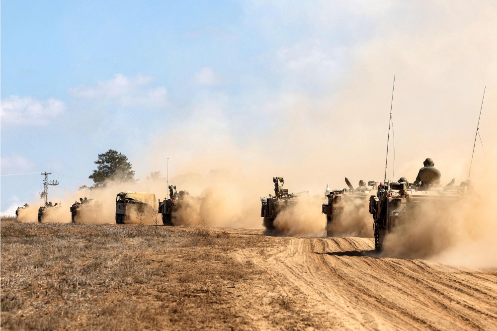 Israeli army tanks and vehicles deploy along the border with the Gaza Strip in southern Israel. — AFP pic