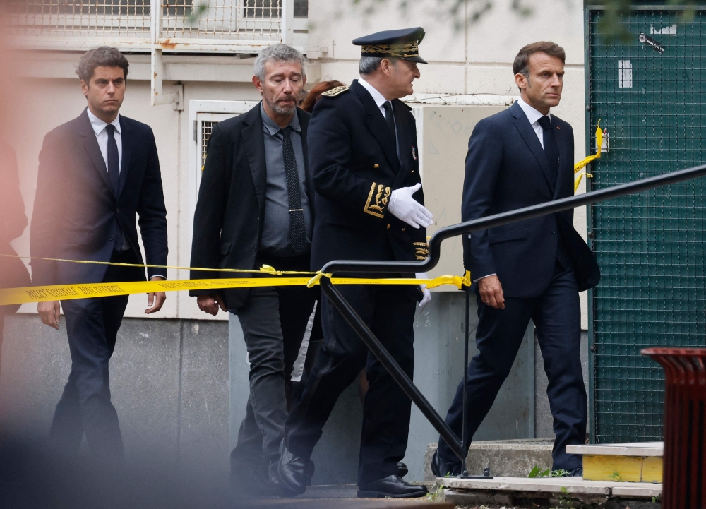 French President Emmanuel Macron (right) and French National Education Minister Gabriel Attal (left) arrive at the Gambetta high school in Arras. — AFP pic