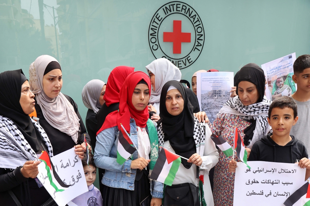 Palestinians gather for a vigil outside the offices of the International Committee of the Red Cross in Beirut on October 11, 2023, in support of the Palestinians in Gaza. — AFP pic