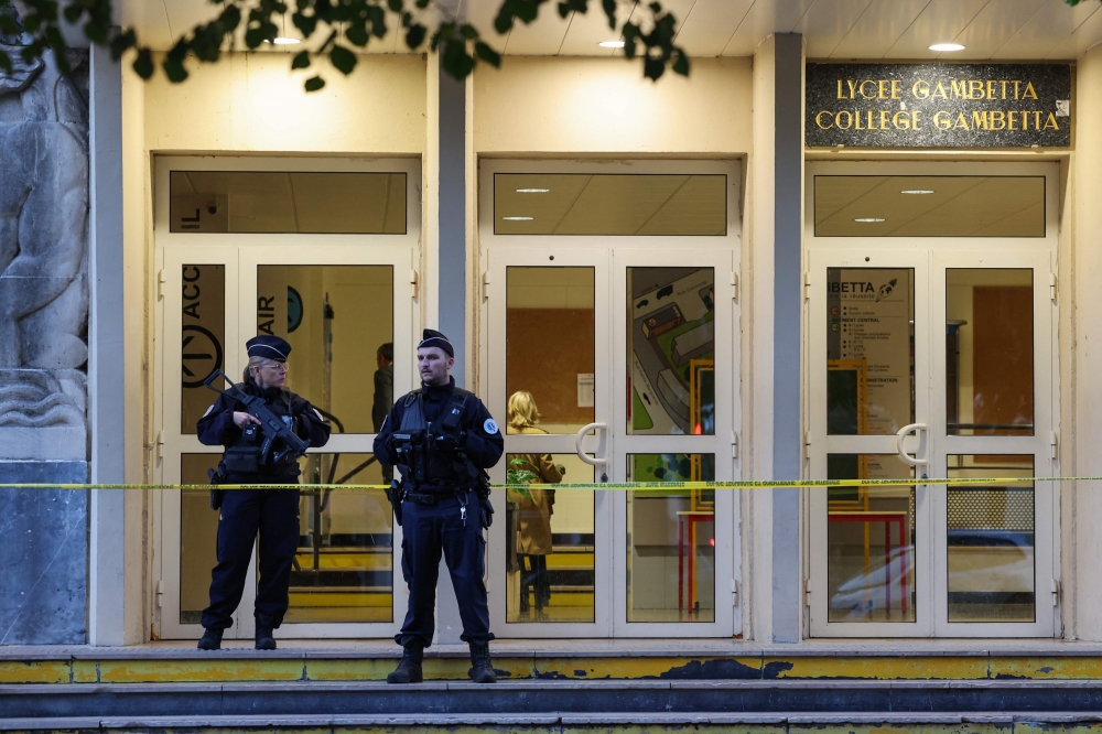 French Police officers stands guard at the entrance of the Gambetta high school in Arras, northeastern France on October 14, 2023, the day after a teacher was killed and two other people severely wounded in a knife attack. — AFP pic