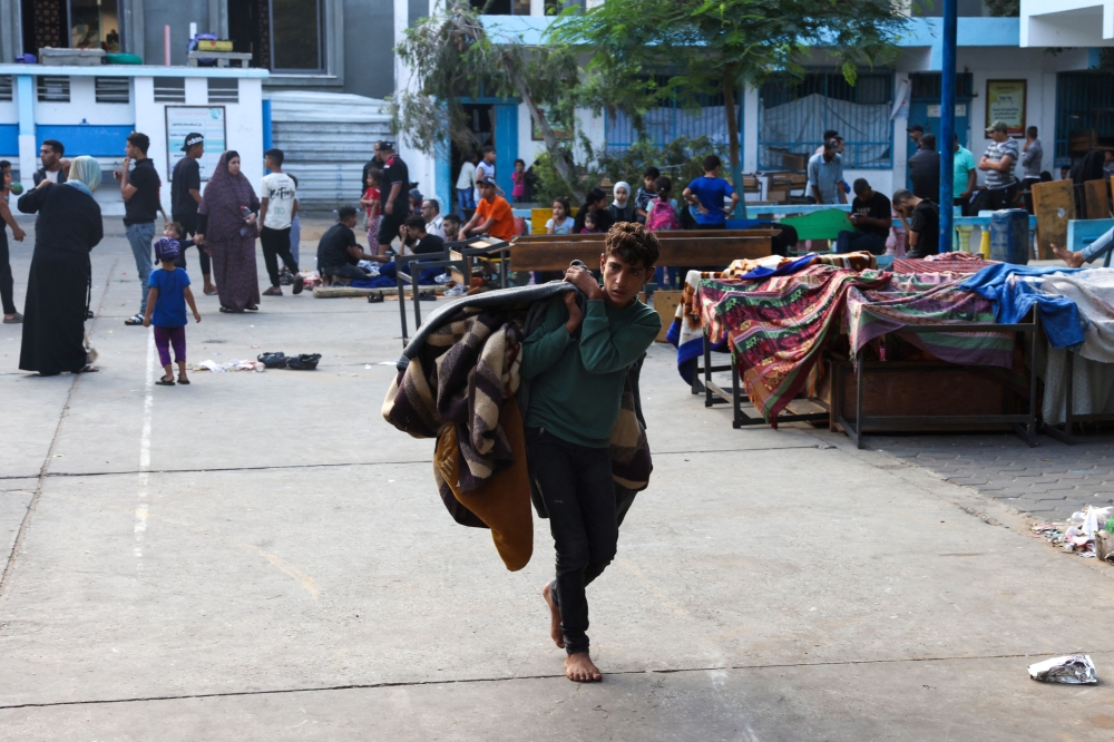Internally displaced Palestinians take refuge in a United Nations school, in the Rafah refugee camp, in the southern of Gaza Strip on October 14, 2023, as fighting between Israel and the Hamas movement continues for the eighth consecutive day in the Gaza Strip enclave. — AFP pic