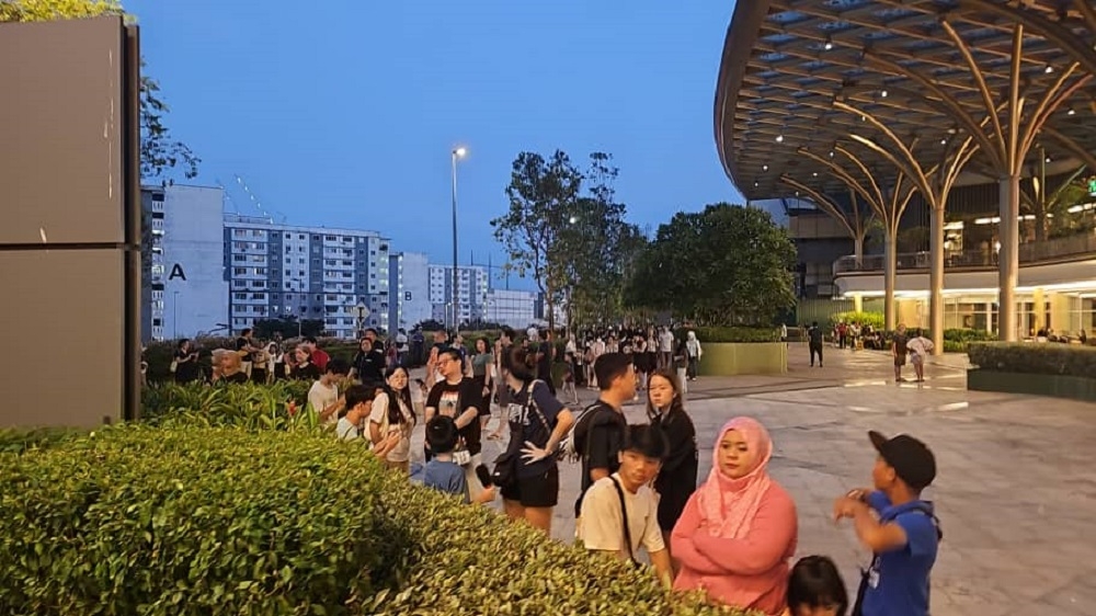 People are seen outside the Mid Valley Southkey shopping centre in Johor Baru after the evacuation. — Picture via social media