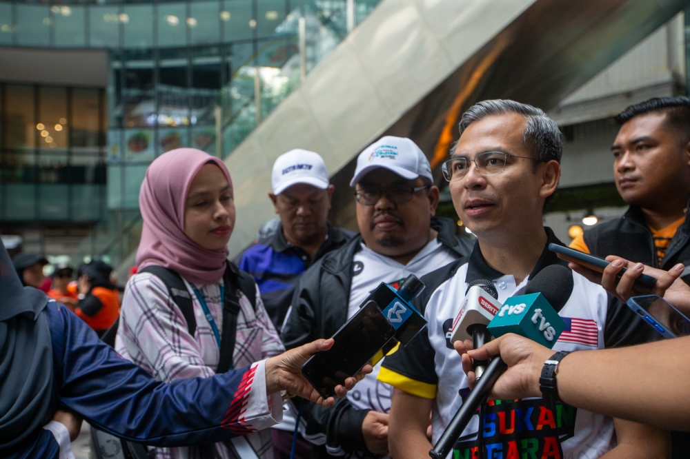 Communications and Digital Minister Fahmi Fadzil speaks to the media after the Kuala Lumpur 2023 National Sports Day celebration at KL Gateway Mall 2 in Kampung Kerinchi. October 14, 2023. — Picture by Raymond Manuel