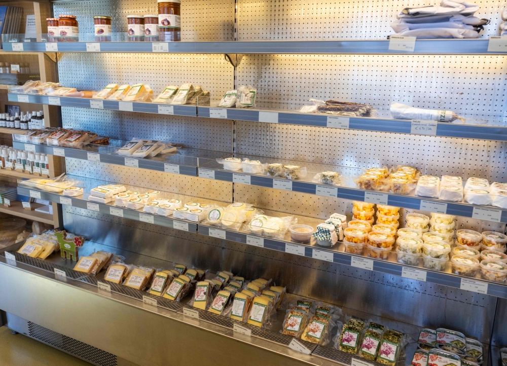 Cheese and other food is displayed at the farm shop. — AFP pic