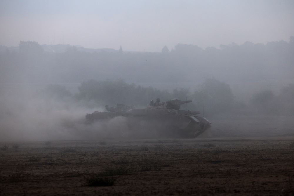 An Israeli armoured vehicle is seen in the aftermath of a mass infiltration by Hamas gunmen from the Gaza Strip, in Kibbutz Beeri in southern Israel, October 14, 2023. — Reuters pic