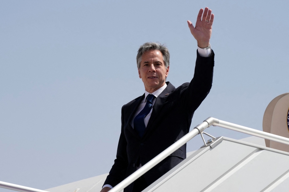 US Secretary of State Antony Blinken waves as he boards a plane leaving Riyadh Oct. 15, 2023. — Reuters pic   