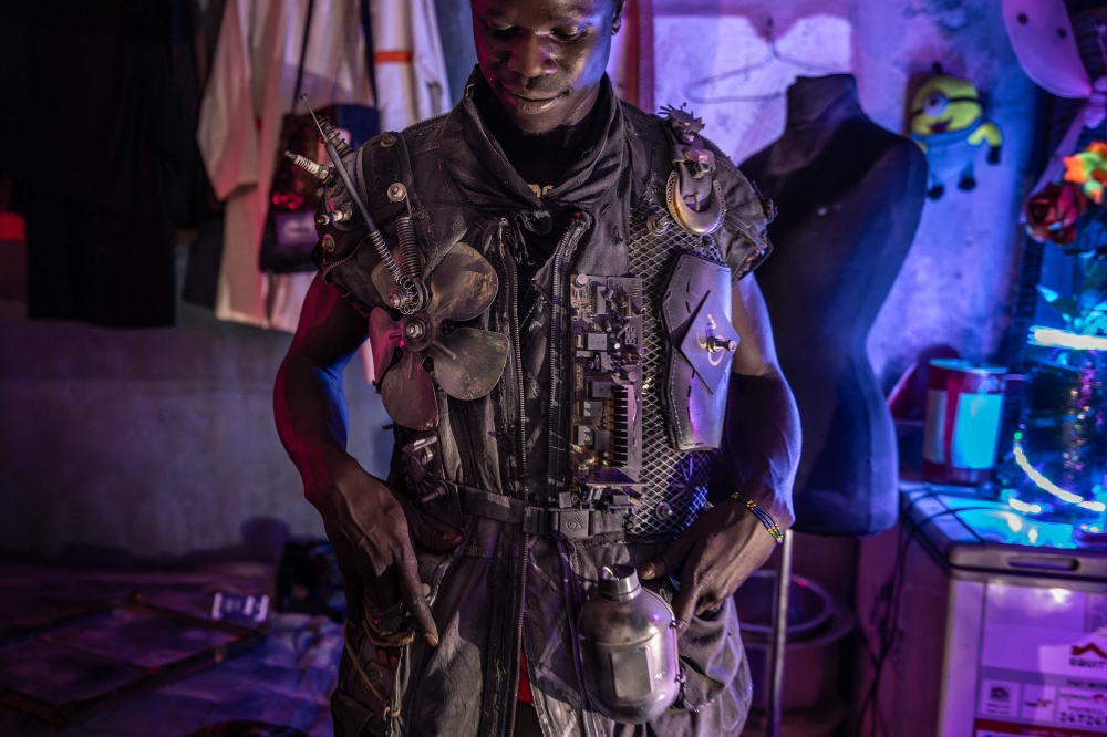 Fashion designer Pius Ochieng fits in one of his dystopian inspired designs at his house and creative studio in the informal settlement of Kibera in Nairobi, on September 25, 2023 ahead of the Kibera Fashion Week. — AFP pic