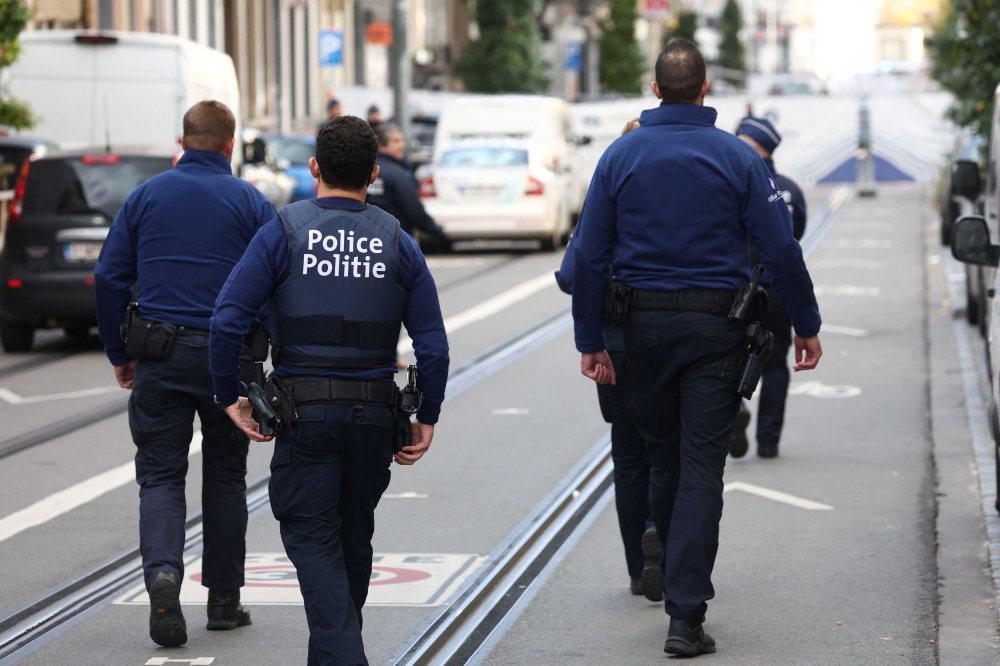 Police officers work after a police operation against a deadly shooting suspect, in Schaerbeek, Brussels, Belgium, October 17, 2023. — Reuters pic