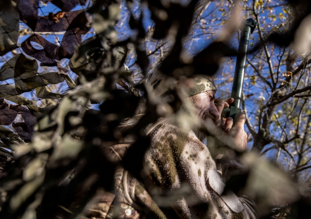 A Ukrainian serviceman observes an area at a position near a frontline, amid Russia's attack on Ukraine, in Donetsk region, Ukraine October 15, 2023. — Reuters pic