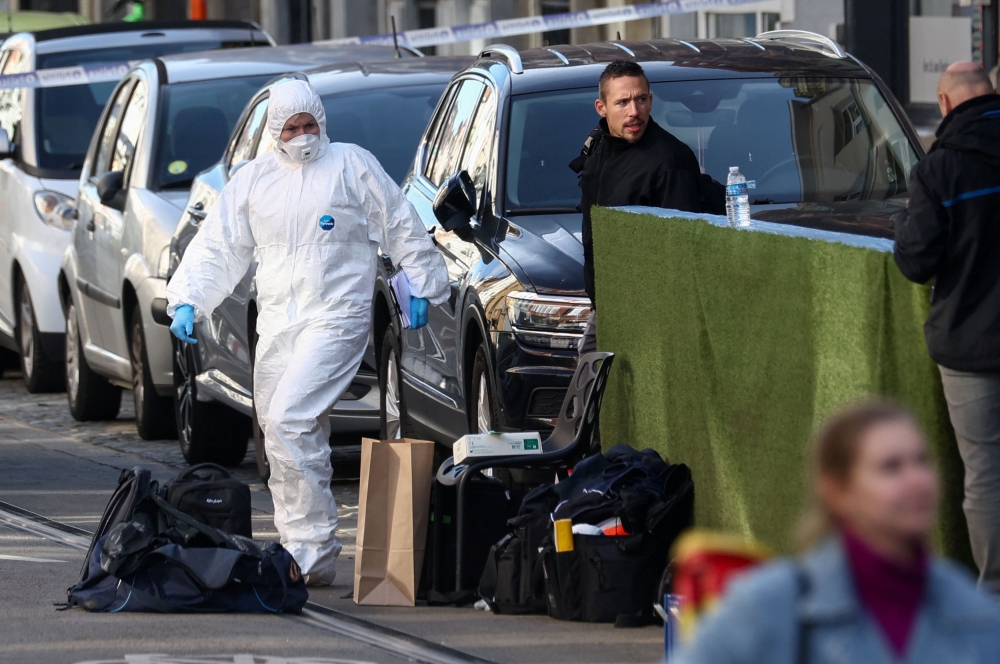 Police officers work after a police operation against a deadly shooting suspect, in Schaerbeek, Brussels, Belgium, October 17, 2023. — Reuters pic
