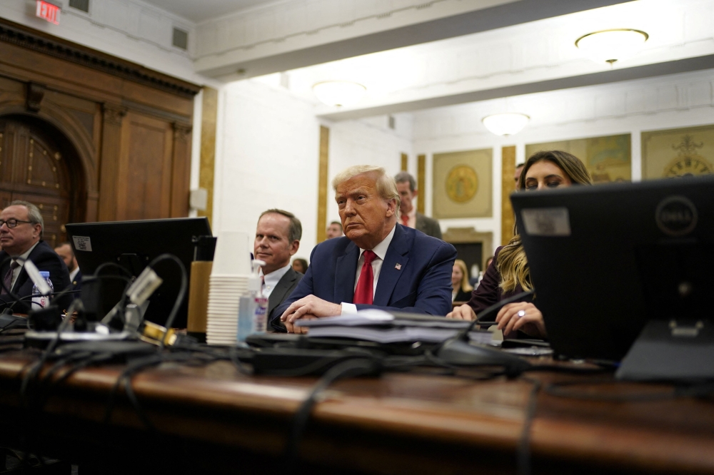 Trump, frontrunner for the Republican presidential nomination, arrived off a Monday campaign stop in Iowa and after a weeklong absence from the trial, centering on allegations that he inflated his net worth to secure more favorable loan terms. — Pool via Reuters pic