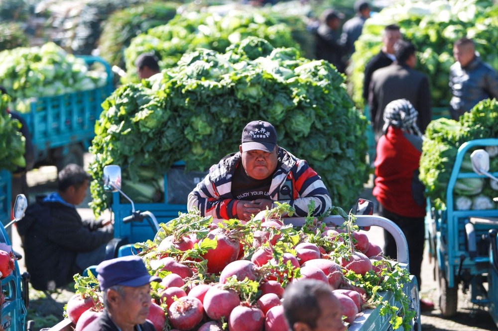 A vendor waits for customers at a market in Shenyang, in China's northeastern Liaoning province on October 16, 2023. — AFP/ China OUT pic 