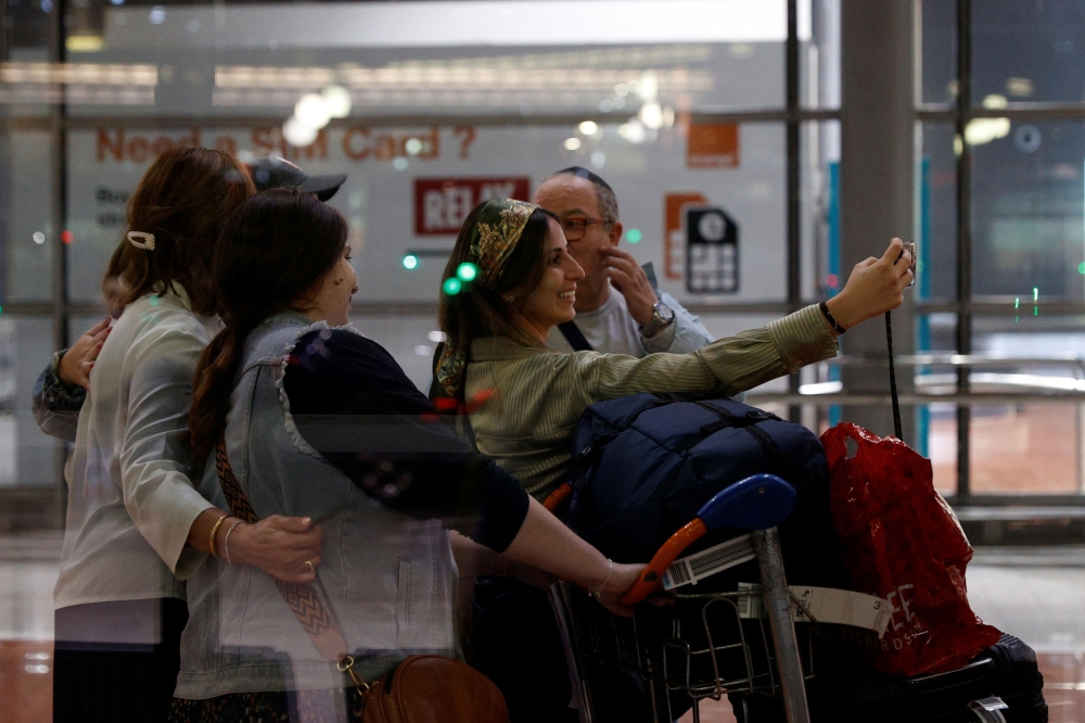 French nationals, who have been repatriated from Israel following days of fighting between Israel and the Palestinian Islamist group Hamas, arrive at the Paris Charles de Gaulle Airport in Roissy, near Paris, France, October 12, 2023. — Reuters pic