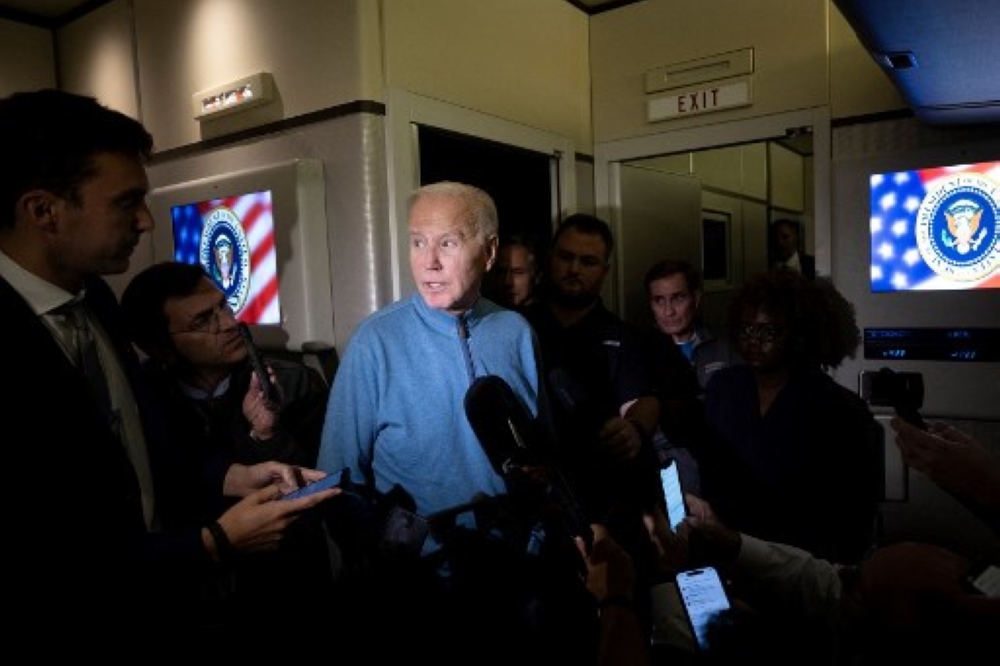 US President Joe Biden speaks to the press aboard Air Force One during a refuelling stop at Ramstein Air Base on October 18, 2023 as he returns from a visit to Israel. — AFP pic