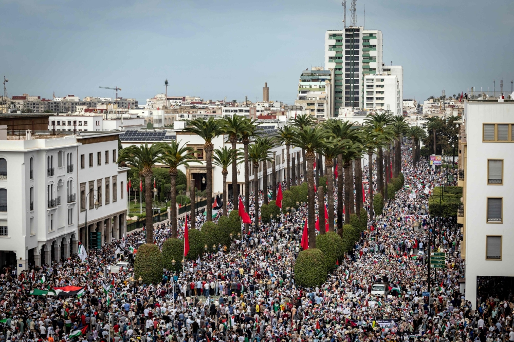 Demonstrators march in Rabat to protest the deaths of hundreds of people in a strike on a Gaza hospital that they blame on Israel, despite its denials. — AFP pic