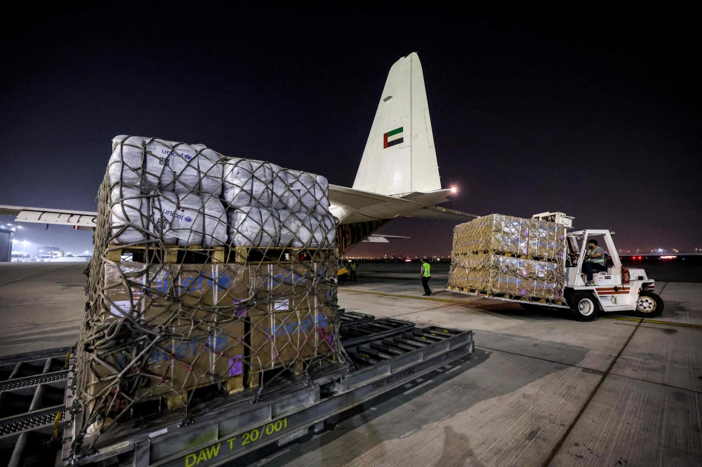 Humanitarian aid provided by the United Nations is loaded onto a United Arab Emirates Air Force C-130H-30 Hercules turboprop military transport aircraft at Dubai International Airport before departure for Cairo. — AFP pic