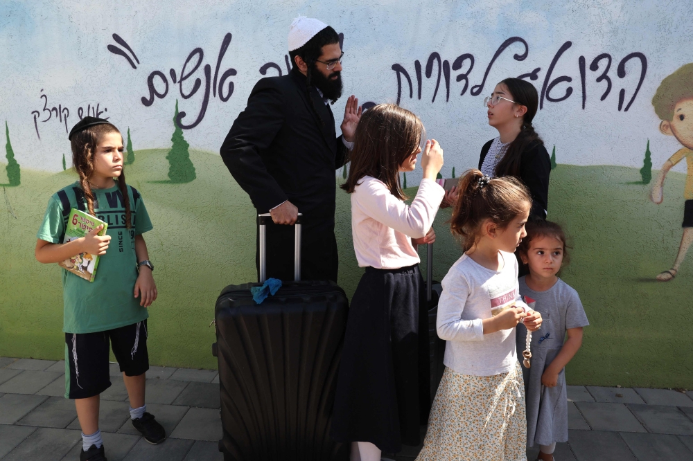 Israelis living in border communities near the Gaza Strip are bracing for a long and hard war with Hamas — some heeding evacuation calls but others staying put. — AFP pic