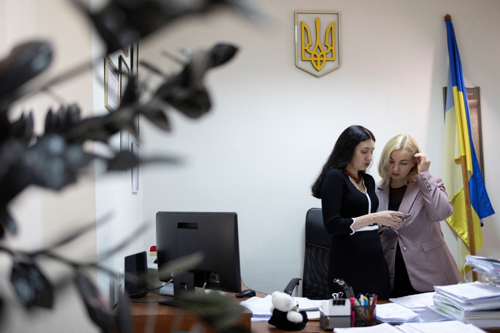 Judges Vira Levko and Yulia Ivanina talk at the Dniprovskyi district court of Kyiv City in Kyiv, amid Russia's attack on Ukraine, October 17, 2023. — Reuters pic