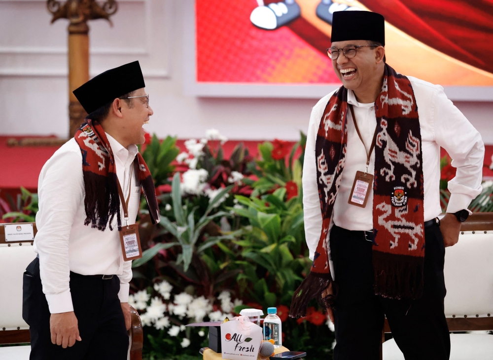 Anies Baswedan, former Jakarta Governor who will run as the presidential candidate for next year's presidential election and his running mate Muhaimin Iskandar, who is the chairman of National Awakening Party (PKB), react as they register themselves at the election commission headquarters in Jakarta, Indonesia, October 19, 2023. — Reuters pic