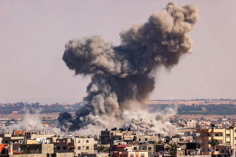 A smoke plume erupts during Israeli bombardment in Rafah in the southern of Gaza Strip on October 19, 2023. — AFP pic