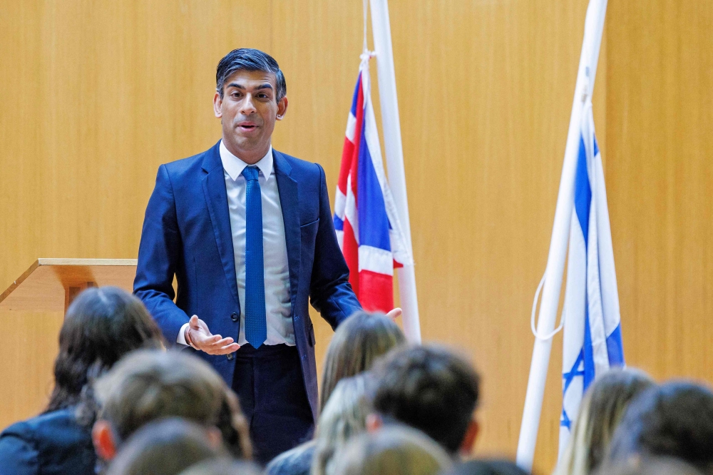 Britain's Prime Minister Rishi Sunak delivers a speech to students of a school in north London, during a visit, on October 16, 2023. — AFP pic