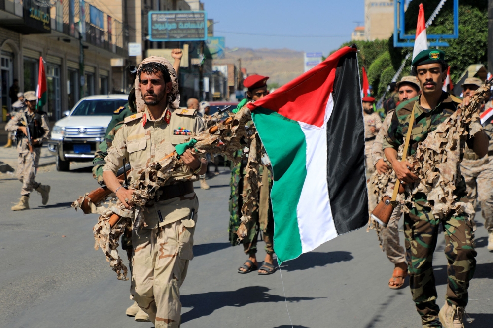 Forces loyal to Yemen's Huthi rebels hold up Palestinian flags as they march in a show of solidarity with the Palestinians on October 15, 2023, in Sanaa. — AFP pic