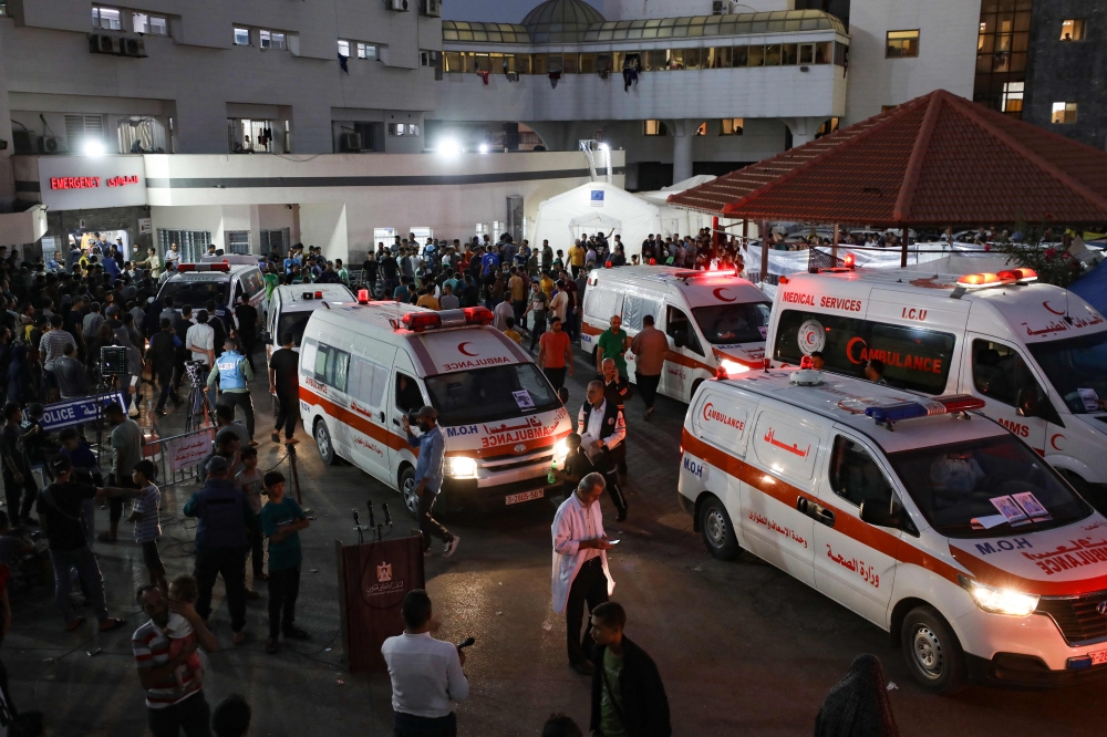 Ambulances carrying victims of Israeli strikes crowd the entrance to the emergency ward of the Al-Shifa hospital in Gaza City on October 15, 2023. — AFP pic