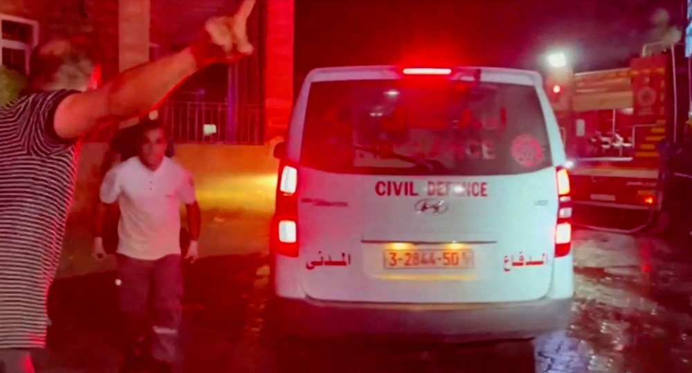 Rescue personnel work at the scene at Al-Ahli Hospital in Gaza City, Gaza Strip, in this screen grab obtained from video, October 17, 2023. ― Reuters pic