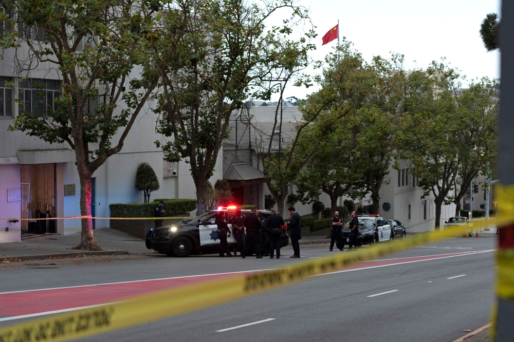 Police officers are seen outside the visa office of the Chinese consulate, where a vehicle crashed into the building, in San Francisco, California, on October 9, 2023. — AFP pic