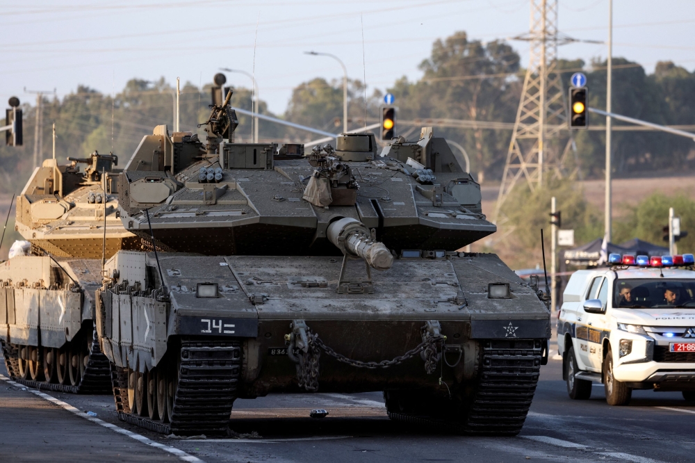 Israeli tanks seen on a road near Israel's border with the Gaza Strip, in southern Israel October 20, 2023. — Reuters pic