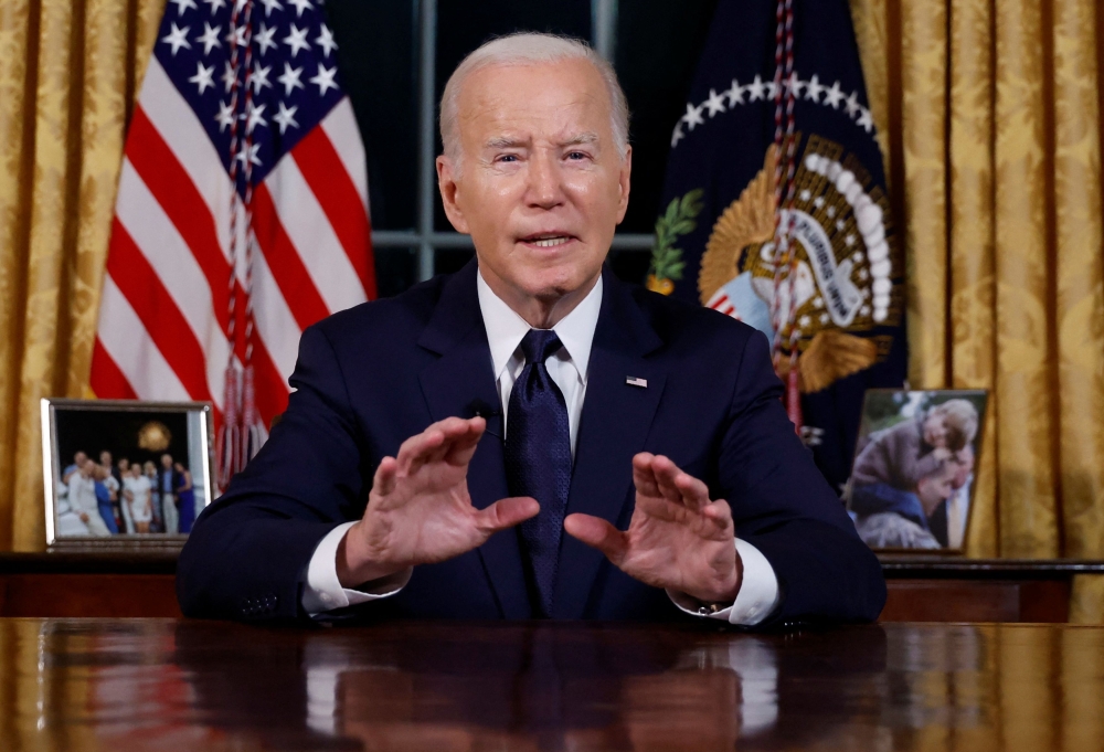 US President Joe Biden delivers a prime-time address to the nation about his approaches to the conflict between Israel and Hamas, humanitarian assistance in Gaza and continued support for Ukraine in their war with Russia, from the Oval Office of the White House in Washington October 19, 2023. — Jonathan Ernst/Pool/Reuters pic