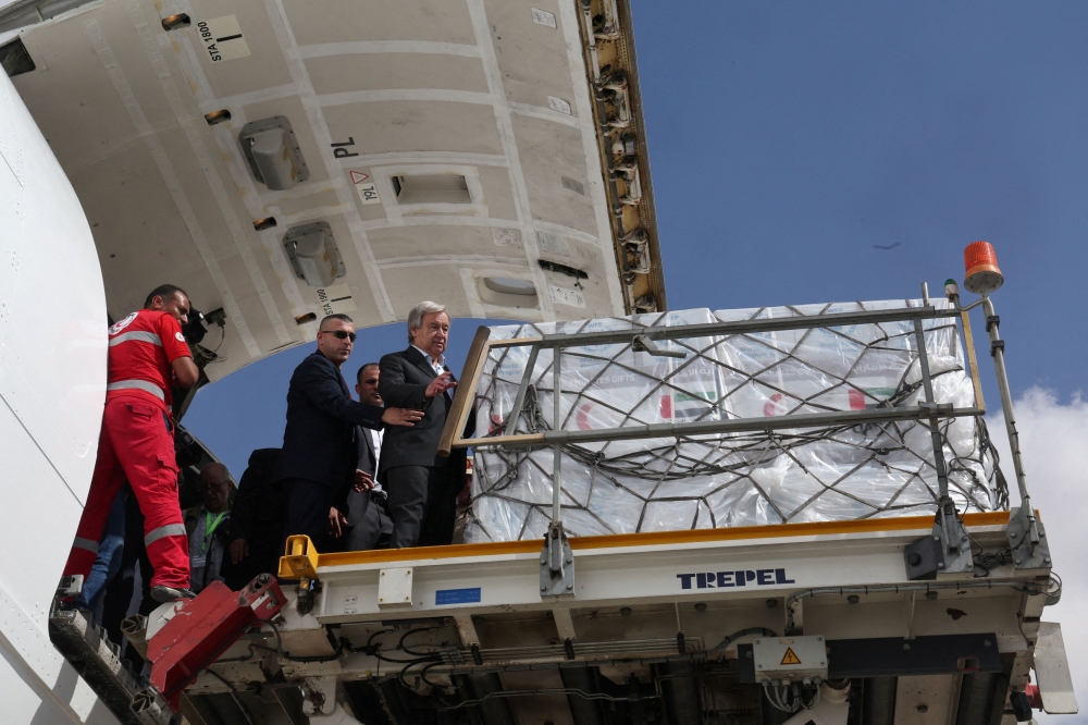 United Nations Secretary-General Antonio Guterres inspects aid for Palestinians, as officials wait to deliver aid to Gaza through the Rafah border crossing between Egypt and the Gaza Strip, amid the ongoing conflict between Israel and the Palestinian Islamist group Hamas, at Al Arish airport October 20, 2023. — Reuters pic
