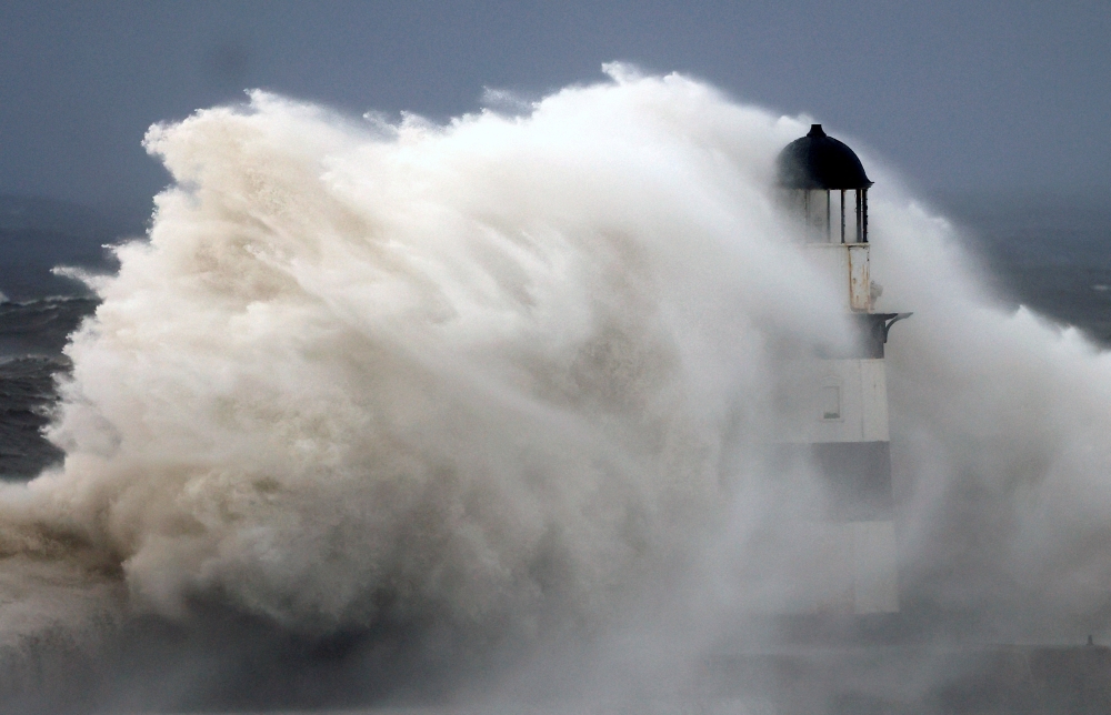 Waves crash against Seaham lighthouse during Storm Babet in Seaham October 20, 2023. — Reuters pic