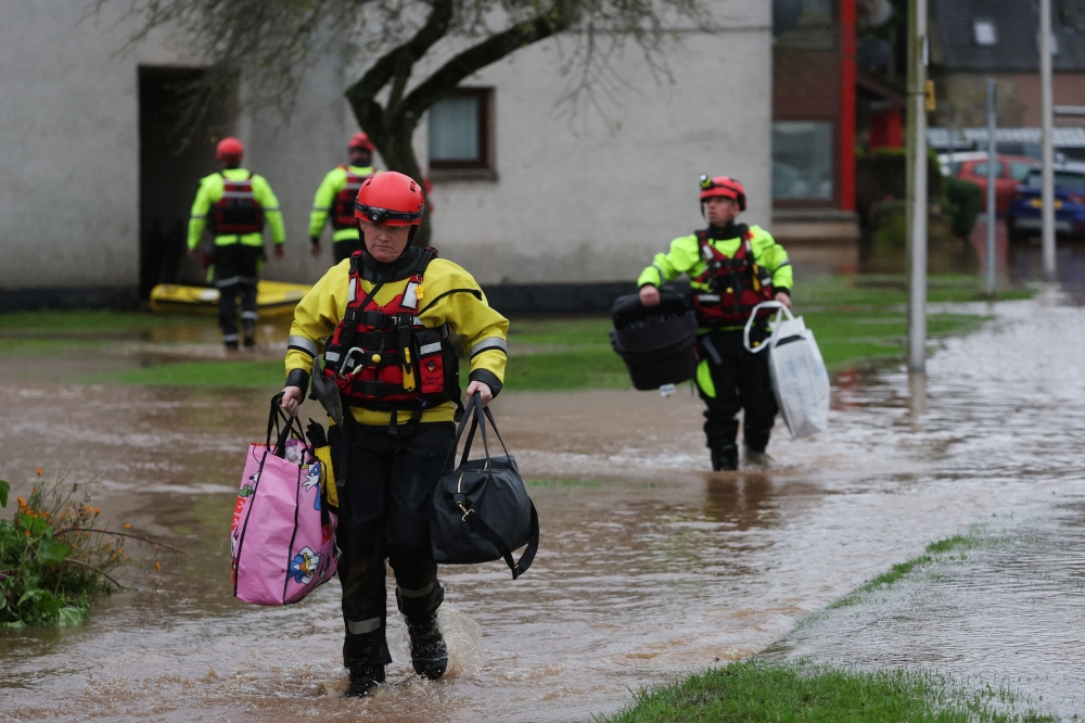 Emergency services assist in the evacuation of people from their homes in Brechin, amid floods during Storm Babet in Scotland October 20, 2023. — Reuters pic