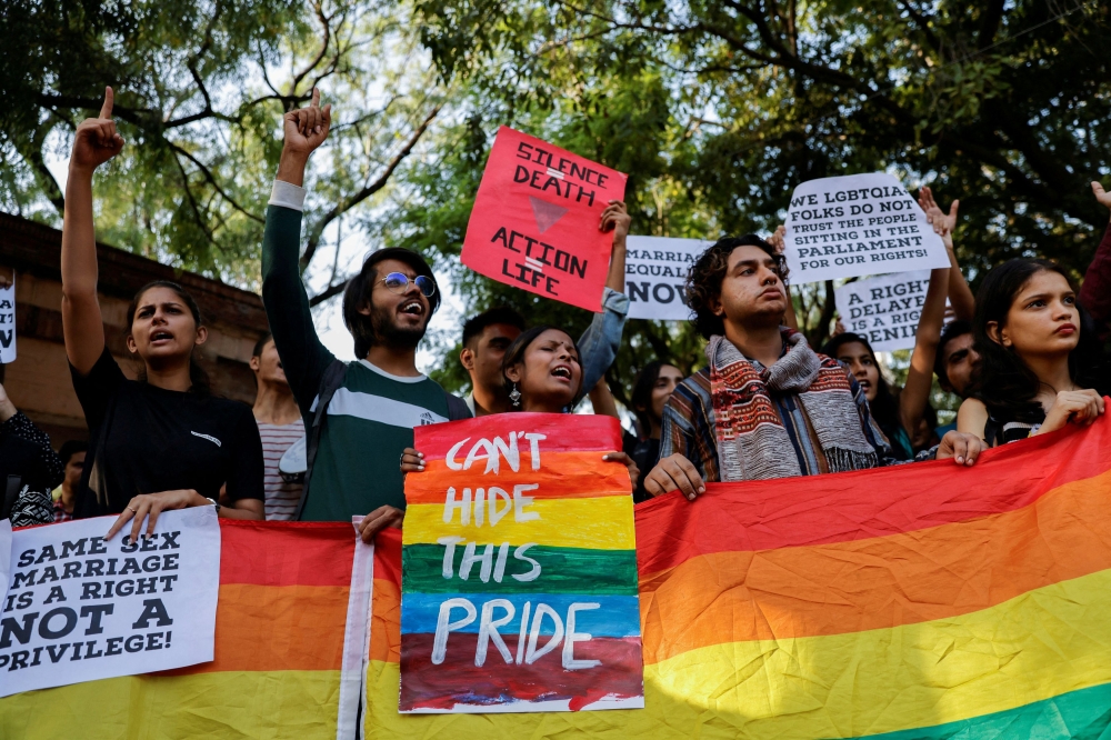 Students and supporters of the Students' Federation of India (SFI) shout slogans, hold placards and pride flags as they take part in an LGBT  Pride vigil organised after India's top court on Tuesday declined to legalise same-sex marriage and left it to parliament to decide, at North Campus in New Delhi October 18, 2023. — Reuters pic