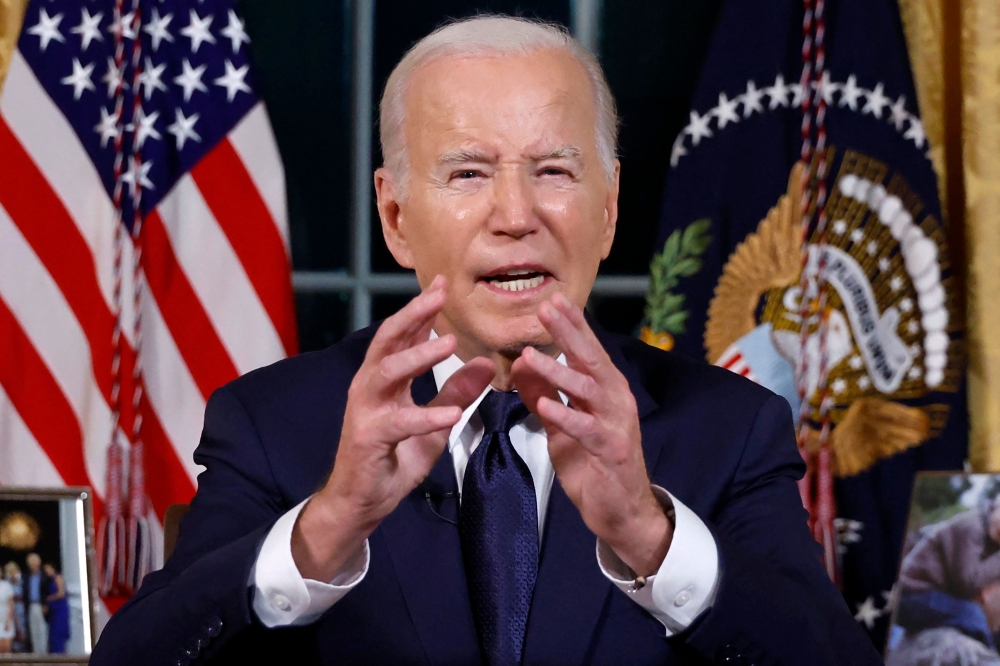 US President Joe Biden addresses the nation on the conflict between Israel and Gaza and the Russian invasion of Ukraine from the Oval Office of the White House in Washington October 19, 2023. — Pool pic via AFP
