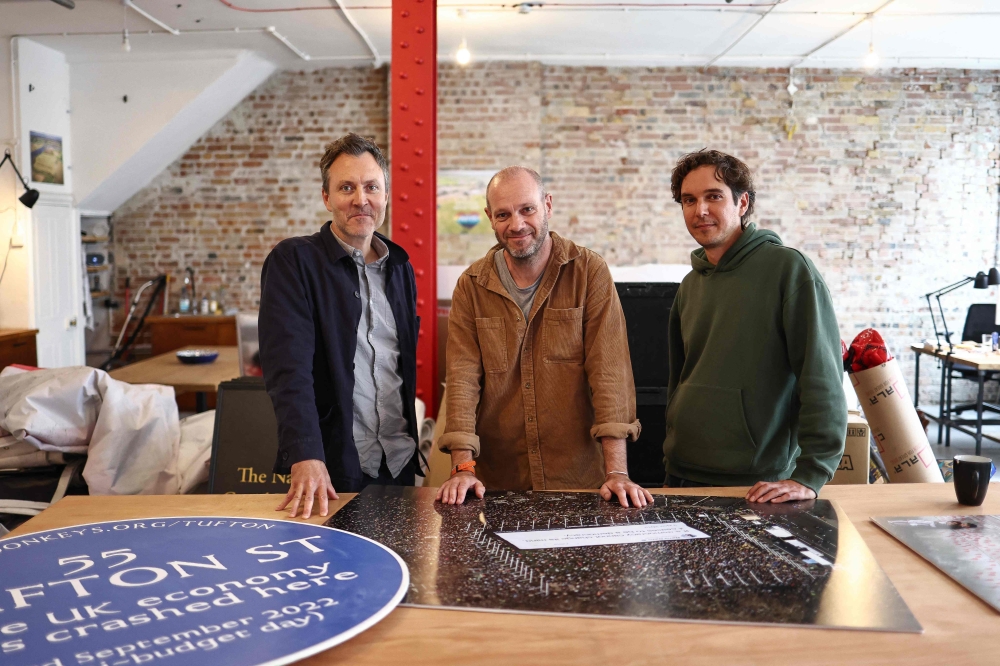 (From left) Oliver Knowles, Ben Stewart and James Sadri of political activist group ‘Led By Donkeys’, pose for a picture inside their offices in London on October 11, 2023. — AFP pic