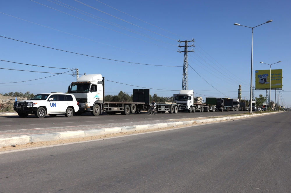 Empty trucks wait on the Gaza border with Egypt at Rafah for the aid trucks to cross from northern Egypt on October 21, 2023, amid the ongoing battles between Israel and the Palestinian group Hamas. — AFP pic