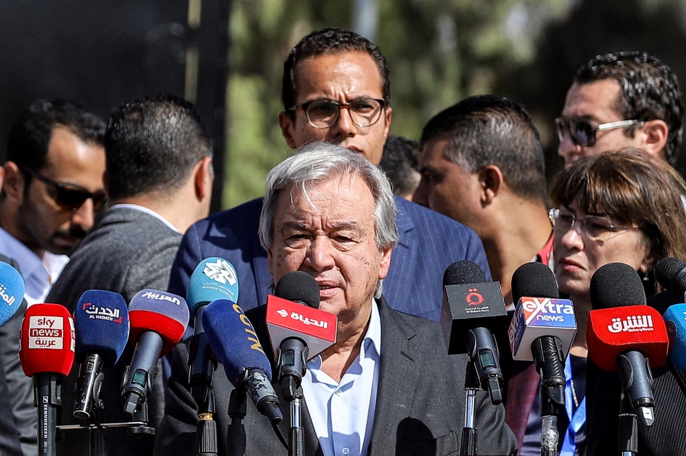 United Nations Secretary-General Antonio Guterres (centre) speaks outside the gate of the Egyptian side of the Rafah border crossing with the Gaza Strip in the east of North Sinai province on October 20, 2023 during a visit there to oversee preparations for the delivery of humanitarian aid to the war-torn Palestinian enclave. — AFP pic