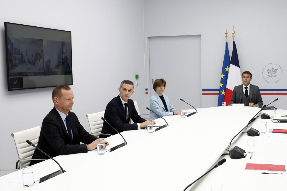 French President Emmanuel Macron and French Foreign and European Affairs Minister Catherine Colonna attend a video-conference with the families of French hostages by the Hamas militants who had entered Israel from the Gaza Strip, at the Elysee Palace in Paris, France, October 20, 2023.— Reuters pic
