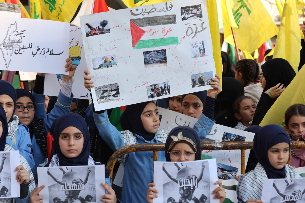 Supporters of the Lebanese Shiite movements Hezbollah and Amal attend gather in the southern suburb of Beirut on October 20, 2023, to show solidarity with the Palestinian people. — AFP pic